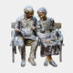 Life-Size Traditional Elderly Couple on Bench Bronze Sculpture by Giant Sculptures, man holding an open book beside a woman with a cat in her lap.