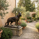 Life-Size Traditional German Shepherd Bronze Sculpture by Giant Sculptures on a weathered stone plinth in a Tuscan courtyard with olive trees and lavender.