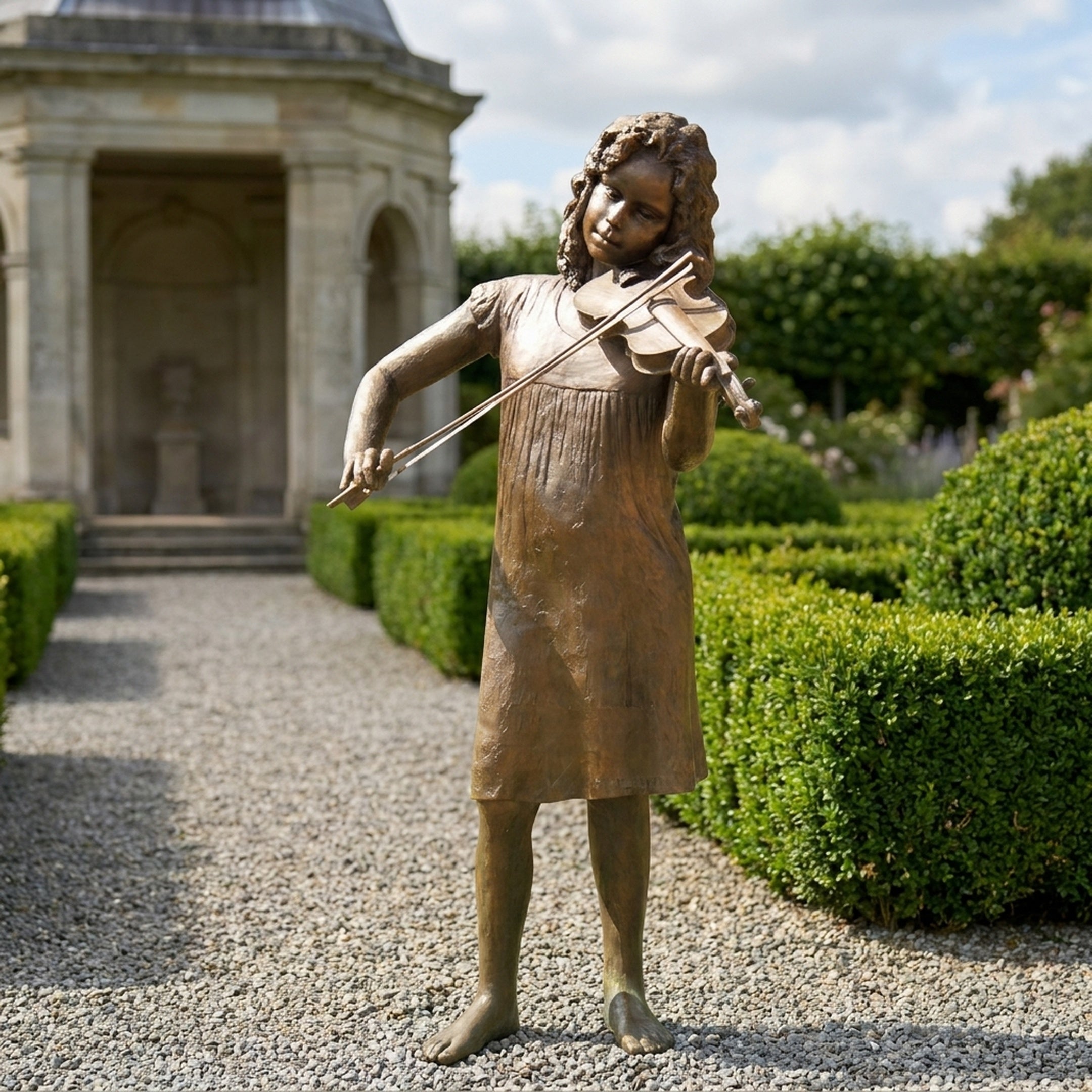 Life-Size Traditional Girl Playing Violin Bronze Sculpture by Giant Sculptures, 180cm, displayed on a gravel garden path beside clipped hedges and a stone pavilion.
