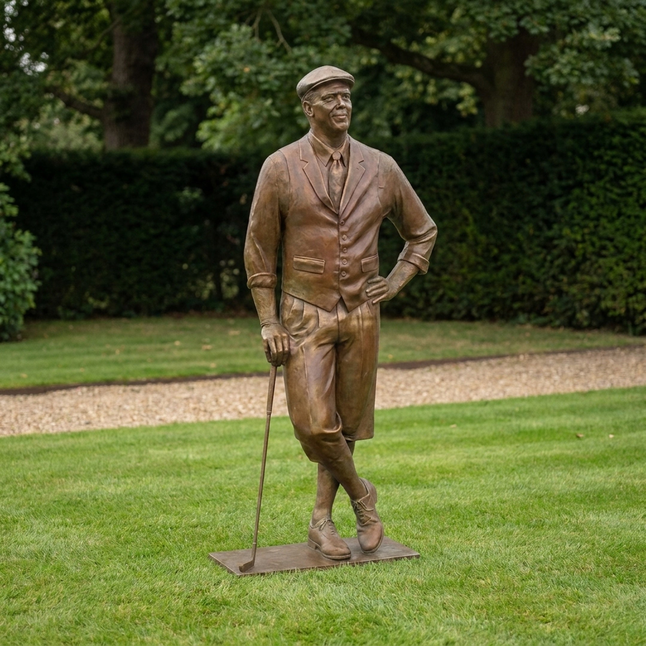 Life-Size Traditional Male Golfer Bronze Sculpture by Giant Sculptures, shown on grass with a club in hand, wearing a flat cap, waistcoat and knickerbockers.