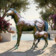 Life-Size Traditional Mare and Foal Bronze Sculpture by Giant Sculptures on a stone poolside terrace, framed by olive trees and bougainvillea.