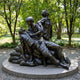 Giant Sculptures Life-Size Traditional Nurse and Soldiers Bronze Sculpture 220cm, dark patina group with nurse cradling a wounded soldier on a granite plinth.
