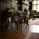 Life-Size Traditional Pair of Greyhounds Bronze Sculpture by Giant Sculptures, dark brown patina, displayed on hardwood floor beside a wood-panelled study desk.
