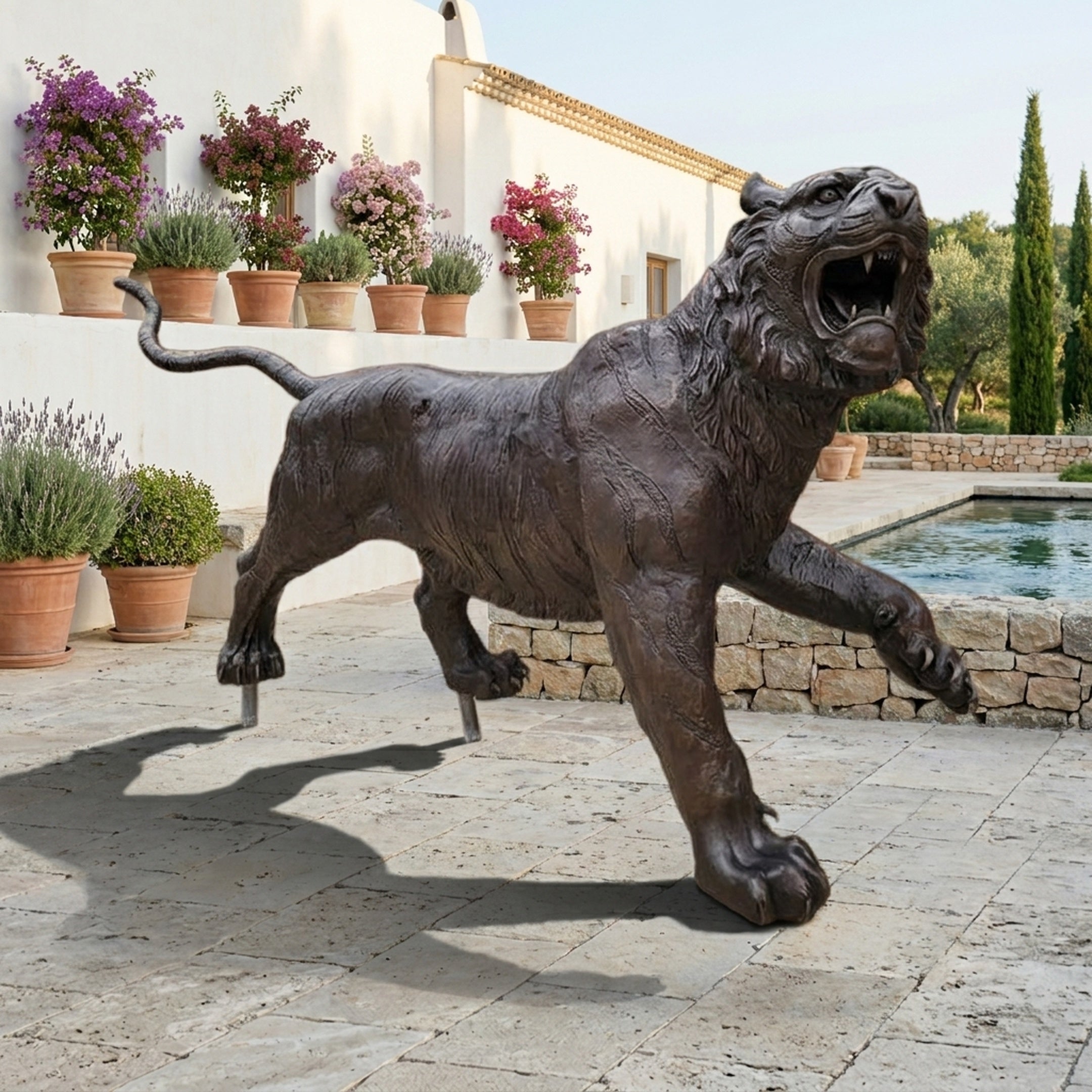 Life-Size Traditional Prowling Tiger Bronze Sculpture by Giant Sculptures in dark patina, mid-lunge with bared fangs, displayed on a poolside terrace.