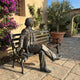 Giant Sculptures Life-Size Traditional Seated Gentleman Bronze Sculpture on a bench in a Mediterranean courtyard with bougainvillea and potted olive tree.