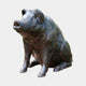 Life-Size Traditional Seated Pig Bronze Sculpture by Giant Sculptures, shown seated upright with head raised, dark patina with green oxidation, on plain background.