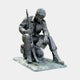 Life-Size Traditional Seated Soldier Bronze Sculpture by Giant Sculptures, dark patina figure in uniform with rifle and helmet, head bowed, on plain background.