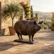 Life-Size Traditional Sow Bronze Sculpture by Giant Sculptures, 120cm, shown in side profile on a Tuscan stone courtyard with olive tree and rolling hills.