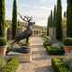 Life-Size Traditional Stag Bronze Sculpture by Giant Sculptures on a stone plinth in a cypress-lined garden path with lavender beds and a classical pavilion.