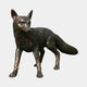 Life-Size Traditional Standing Fox Bronze Sculpture by Giant Sculptures, shown in side view with alert ears and bushy tail, dark patina with copper highlights on plain background.