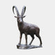 Life-Size Traditional Standing Ibex Bronze Sculpture 300cm by Giant Sculptures, dark brown patina with ridged curved horns, on a rocky base against a plain background.