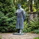 Giant Sculptures Life-Size Traditional Standing Military Figure Bronze Sculpture 220cm in greatcoat and peaked cap, verdigris patina, set on garden paving.