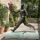 Life-Size Traditional Tennis Player Bronze Statue by Giant Sculptures, mid-stride forehand on a pale marble plinth engraved Henri Cochet, on a stone terrace.