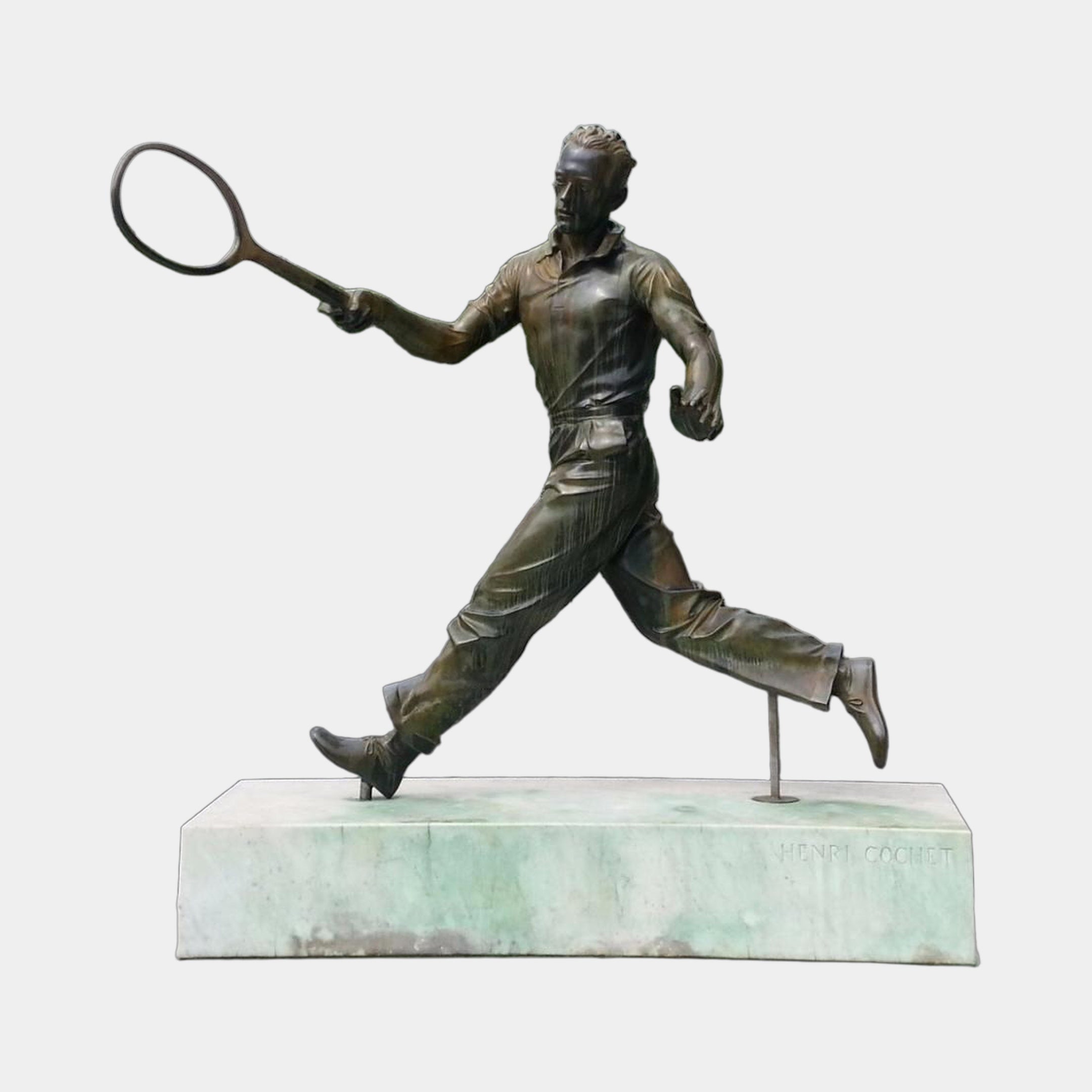 Life-Size Traditional Tennis Player Bronze Statue by Giant Sculptures shown mid-stride in a forehand swing on an engraved Henri Cochet marble plinth.