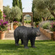 Life-Size Traditional Walking Bear Bronze Sculpture by Giant Sculptures shown mid-stride on a lawn beside lavender and bougainvillea in a Mediterranean garden.