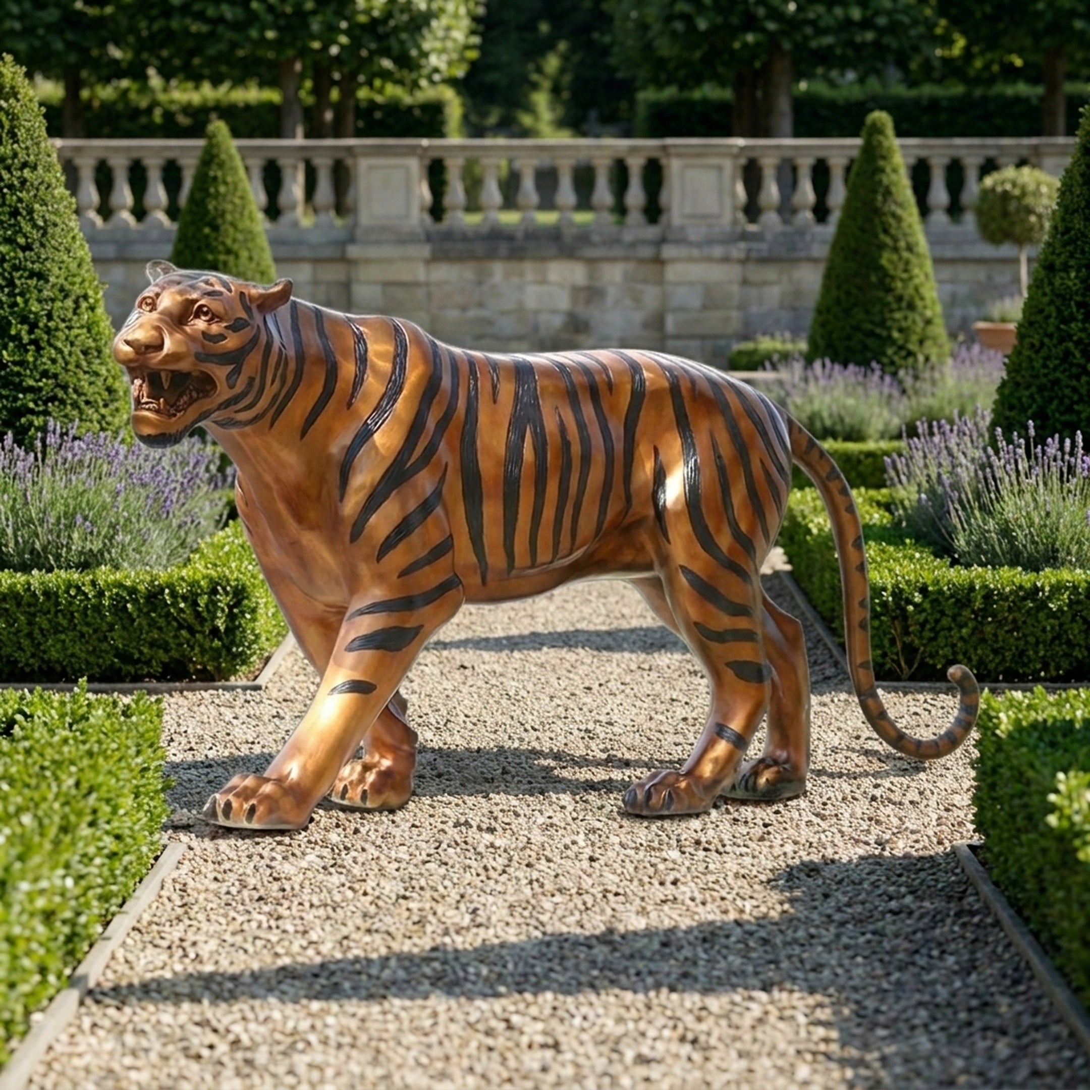 Life-Size Traditional Walking Bengal Tiger Bronze Sculpture from Giant Sculptures in amber and black polychrome finish, displayed on a gravel path in a formal garden.