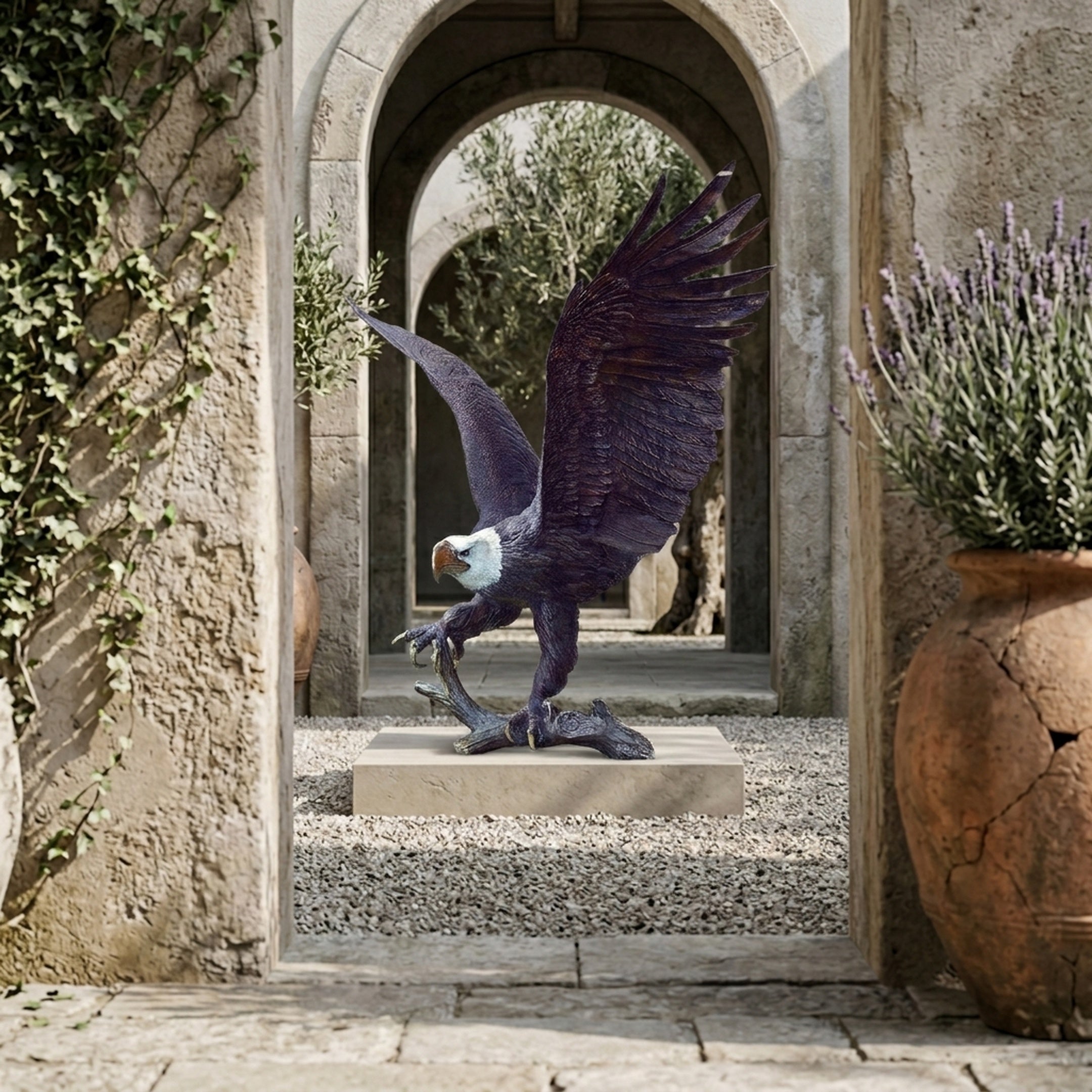 Monumental Bald Eagle Bronze Sculpture by Giant Sculptures with wings raised on a stone plinth, framed by an archway in a Mediterranean courtyard.