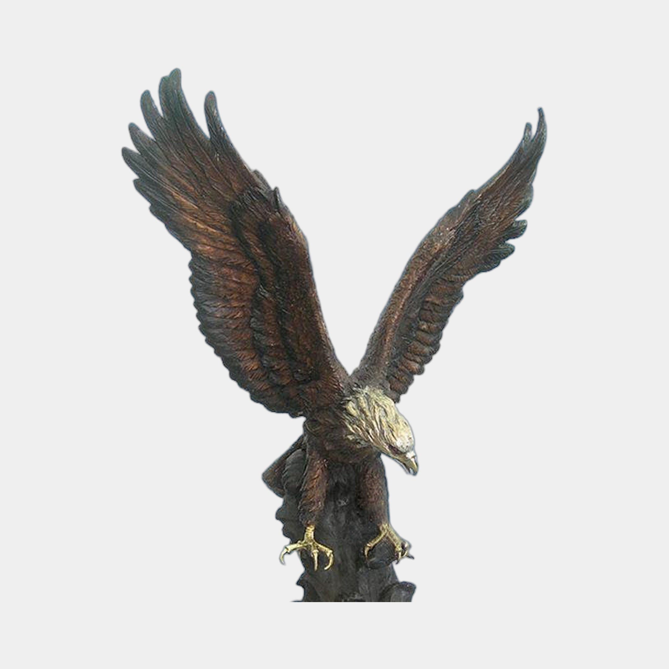 Monumental Bald Eagle Bronze Sculpture by Giant Sculptures shown front-on with wings raised mid-landing, golden head and talons against a warm brown patina body, on a plain background.
