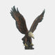 Monumental Bald Eagle Bronze Sculpture by Giant Sculptures shown front-on with wings raised mid-landing, golden head and talons against a warm brown patina body, on a plain background.