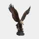 Monumental Bald Eagle Bronze Sculpture by Giant Sculptures shown with wings raised high, golden head lowered and talons gripping a rocky outcrop base.