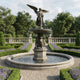 Monumental Classical Angel and Cherub Bronze Fountain by Giant Sculptures with winged angel atop a tiered basin, cherubs below, set in a formal lavender garden.