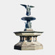 Monumental Classical Angel Bronze Fountain, 800cm, with winged angel atop a tiered basin and cherub-lined colonnade, on a plain light background.