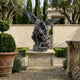 Monumental Classical Archangel Michael Bronze Sculpture by Giant Sculptures, 300cm winged figure chaining a demon, on stone plinth in a Mediterranean garden.