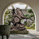 Giant Sculptures Saint George Slaying the Dragon Bronze Statue 300cm, viewed through a stucco archway overlooking a Japanese garden with bonsai and stone lantern.