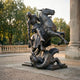 Monumental Classical Armoured Knight and Dragon Bronze Sculpture by Giant Sculptures, rearing horse and lance-bearing knight over a coiled dragon beside stone columns.