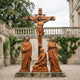Giant Sculptures Monumental Classical Crucifixion Group Bronze Sculpture 600cm in warm ochre patina, Christ on cross with three mourning figures, courtyard setting.