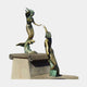 Monumental Classical Dual Mermaid Bronze Sculpture by Giant Sculptures, two figures with golden-bronze bodies and green patina tails reaching toward each other on a stone plinth.