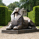 Monumental Classical Egyptian Sphinx Bronze Sculpture by Giant Sculptures, 200cm recumbent figure with nemes headdress on a plinth in a hedged garden path.