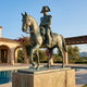 Giant Sculptures 350cm Monumental Classical Military Officer Riding Horse Bronze Sculpture with verdigris patina, displayed on a stone plinth beside a villa pool.