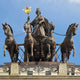 Giant Sculptures Monumental Classical Quadriga Bronze Sculpture atop a building, showing a crowned goddess holding a gilded laurel wreath staff and reins of four horses.