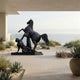 Monumental Classical Rearing Horse and Nude Male Figure Bronze Sculpture by Giant Sculptures on a beachfront terrace with ocean views and agave plants.