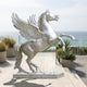 Monumental Classical Rearing Pegasus Bronze Sculpture by Giant Sculptures in pale silver finish, rearing on a plinth on a seaside terrace with planters.
