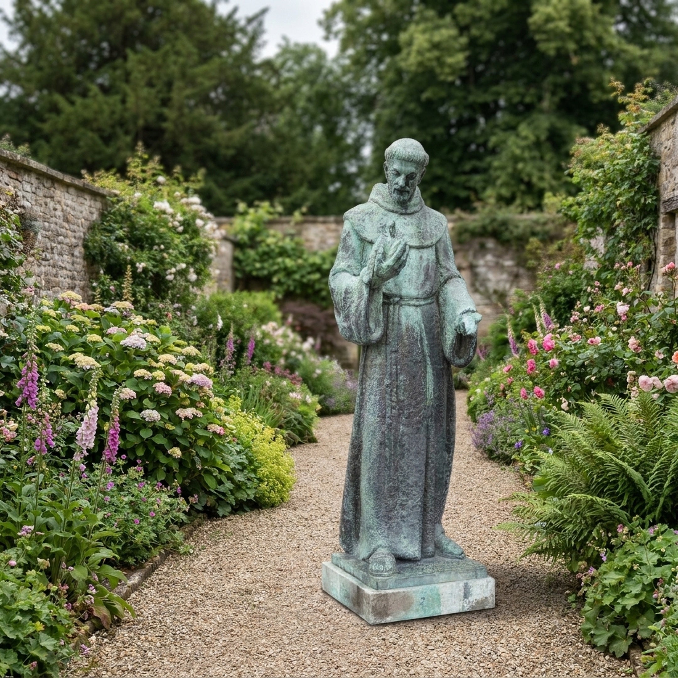 Monumental Classical Robed Saint Bronze Statue by Giant Sculptures with aged verdigris patina, standing on a stone plinth along a gravel path in a walled flower garden.