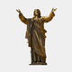 Monumental Classical Sacred Heart Jesus Bronze Statue, 400cm, arms raised in welcoming pose with flowing robes and Sacred Heart emblem, on a round base against a plain light background.
