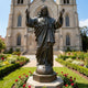 Giant Sculptures Monumental Classical Sacred Heart of Jesus Bronze Statue 400cm, arms raised in blessing atop a globe with cross, set in a cathedral garden.
