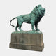 Monumental Classical Standing Lion Bronze Sculpture by Giant Sculptures with verdigris patina, shown in side profile on a stone pedestal against white.