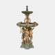 Monumental Classical Three Cherubs Fountain by Giant Sculptures in golden-bronze with verdigris patina, twin tiered basins above three putti, shown on plain background.