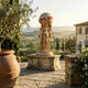 Monumental Classical Three Goddesses and Globe Bronze Sculpture by Giant Sculptures, gold-finished figures holding a globe marked THE WORLD, on a Tuscan terrace.