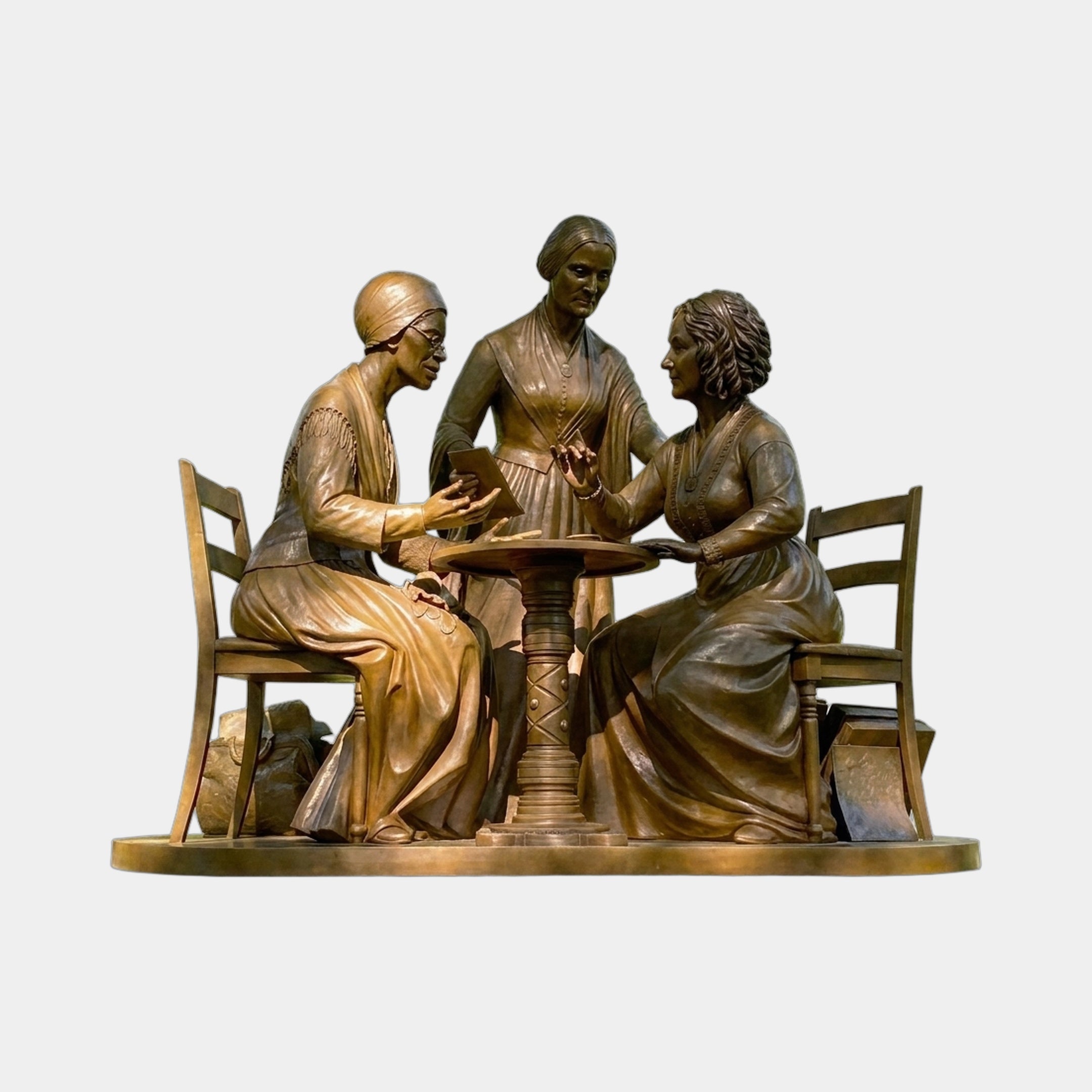 Giant Sculptures Monumental Classical Three Seated Figures Bronze Sculpture showing three women in period dress around a pedestal table on an oval base.