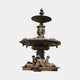 Monumental Classical Tiered Bronze Fountain by Giant Sculptures with reclining draped maidens, cherubs, scalloped basins, and bird finial on a plain background.
