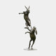 Monumental Contemporary Boxing Hares Bronze Sculpture by Giant Sculptures, 220cm, two stacked hares with dark brown and olive-green patina on plain background.