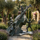 Monumental Contemporary Children with Double Bass Bronze Sculpture by Giant Sculptures, 220cm, in a Mediterranean garden with olive trees and lavender.