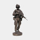 Monumental Contemporary Combat Soldier Bronze Statue by Giant Sculptures, front view of an armed infantryman in helmet and gear on a round base, plain background.