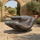 Monumental Contemporary Cupped Hand Bronze Sculpture 150cm by Giant Sculptures, displayed on a stone courtyard beside a Mediterranean archway and olive tree.