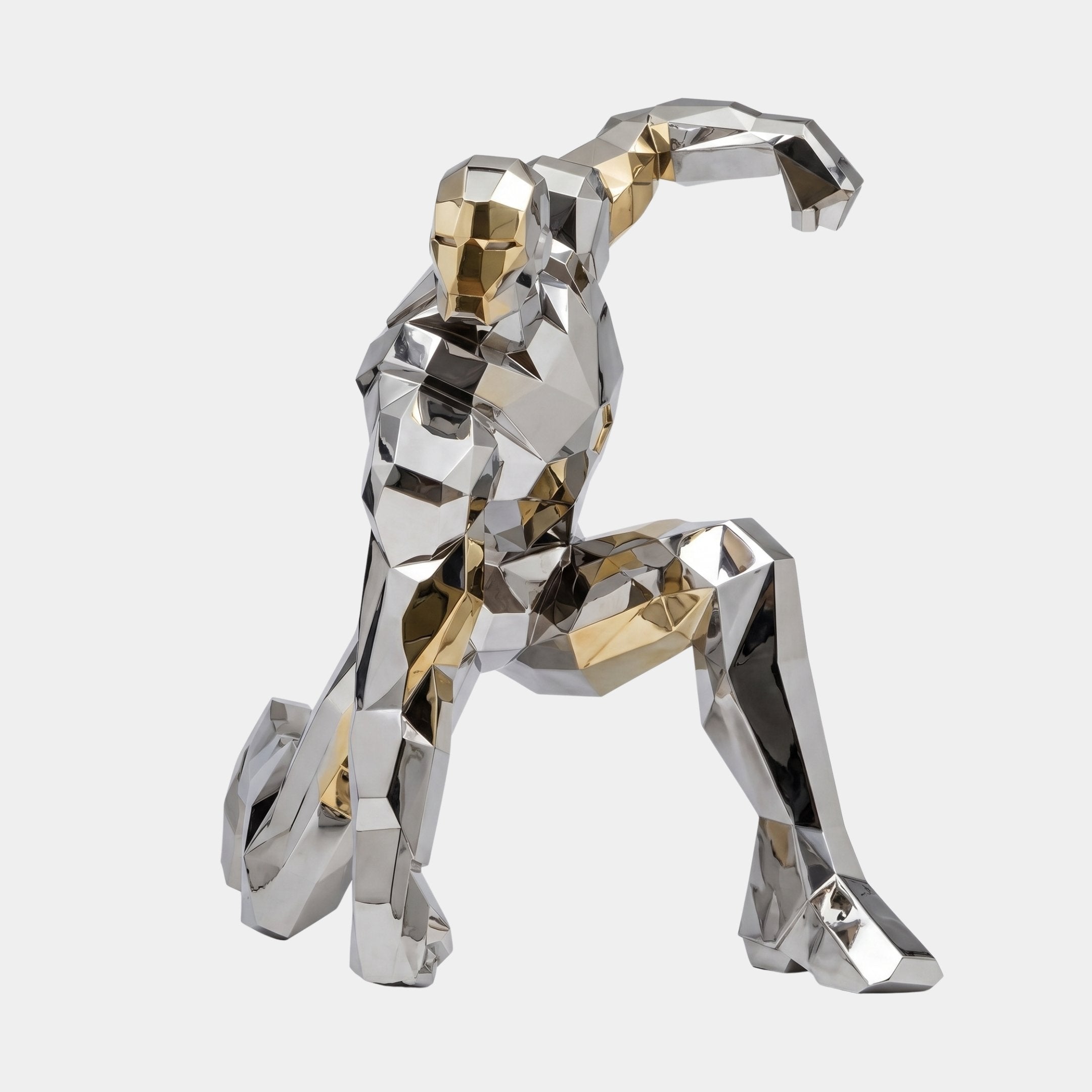 Giant Sculptures Monumental Contemporary Geometric Sprinting Figure in faceted mirror-polished silver and gold tones, mid-sprint pose, on a plain light background.