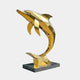 Monumental Contemporary Leaping Dolphin Bronze Sculpture by Giant Sculptures in mirror-polished gold low-poly facets, arched on a dark granite plinth.